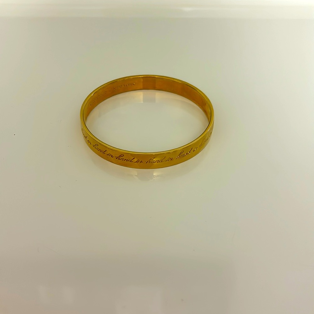 Kate Spade “hand in hand” bangle in gold tone